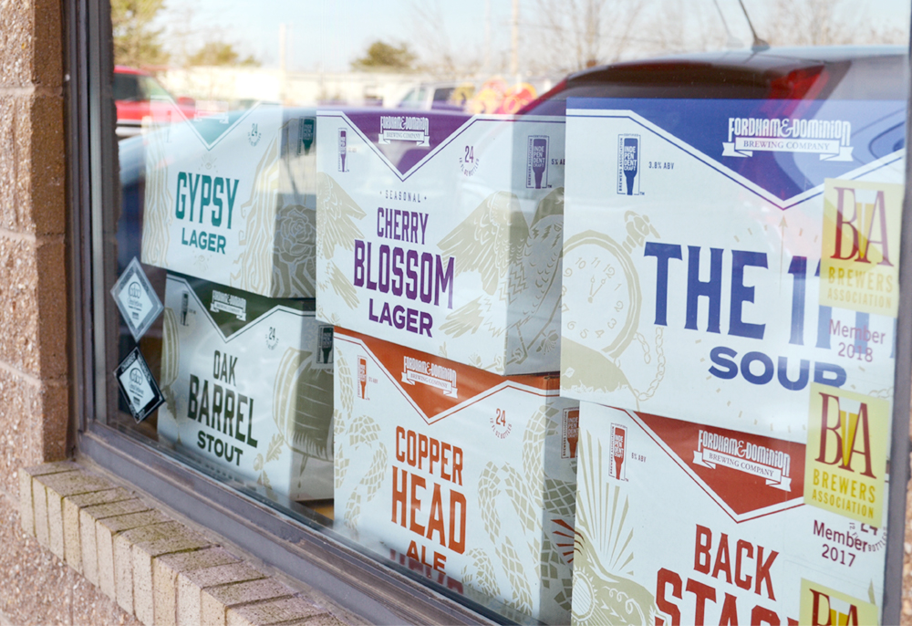 store window with redesigned packs of Fordham & Dominion beer