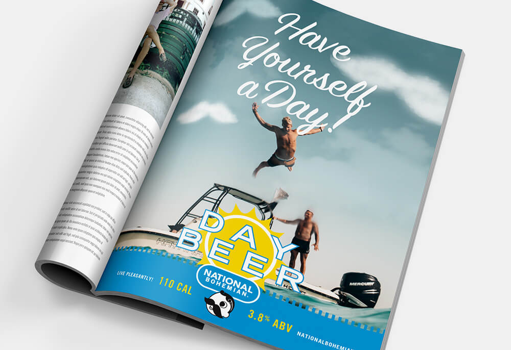 Natty Boh ad in a magazine that displays two man at the beach with the title Have Yourself a Day! Day Beer