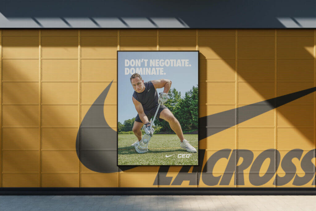 A mocked-up poster of a male lacrosse player scooping a lacrosse ball. The poster reads “Don’t Negotiate. Dominate.”
