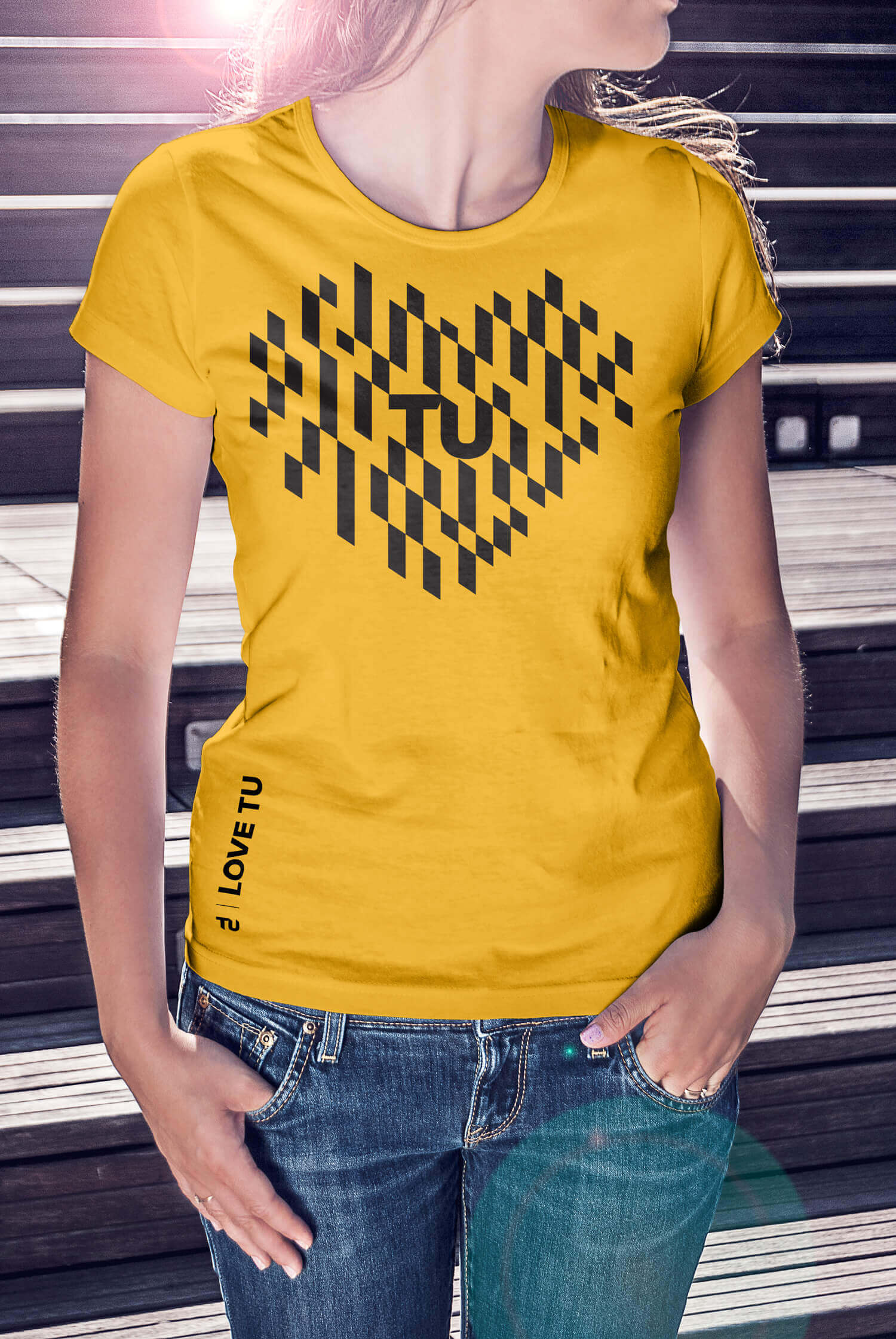 A yellow t-shirt featuring TU brand graphics in the shape of a heart.