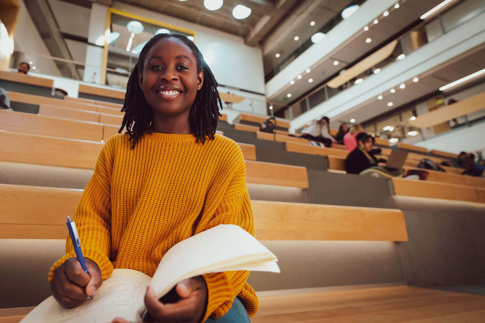 A female student in a large conference hall.