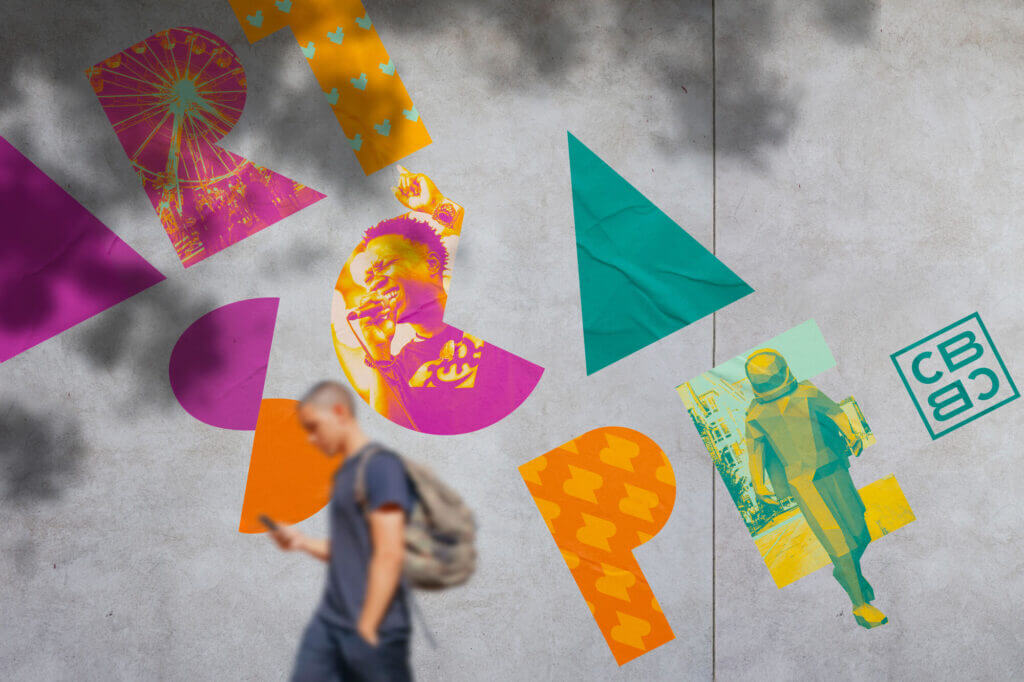 A mocked-up wheatpaste mural showing the Artscape logo. Each letter is either filled with a solid color or an image from the festival.