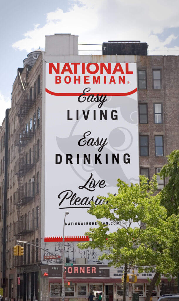 A large scale billboard on an apartment building featuring key brand messaging. It reads “Easy Living Easy Drinking. Live Pleasantly!”
