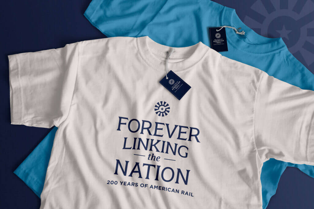 A mocked-up image of two t-shirts featuring the campaign logo and tagline.
