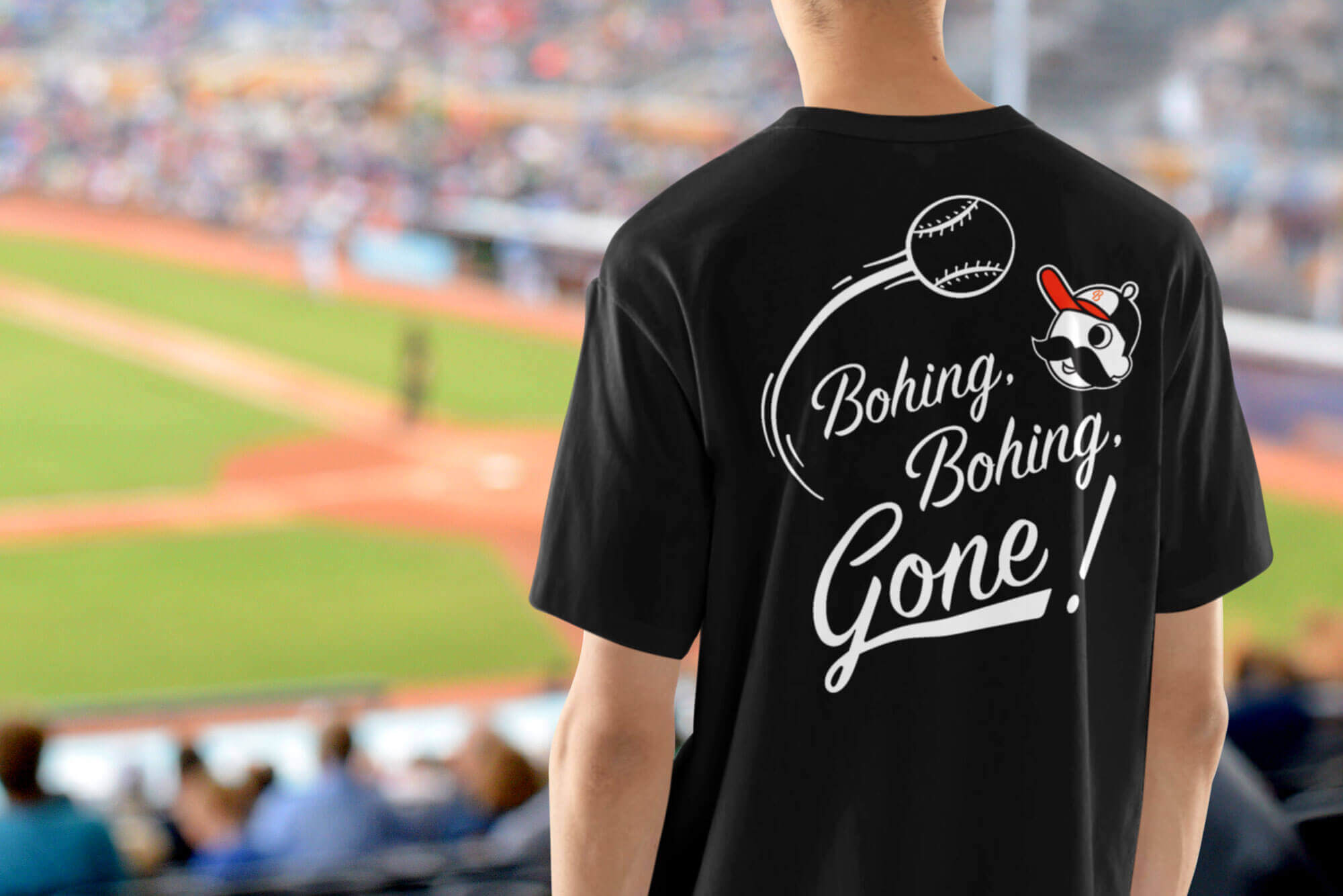 A man wearing a National Bohemian t-shirt at a baseball game The shirt reads, “Bohing, Bohing, Gone!”