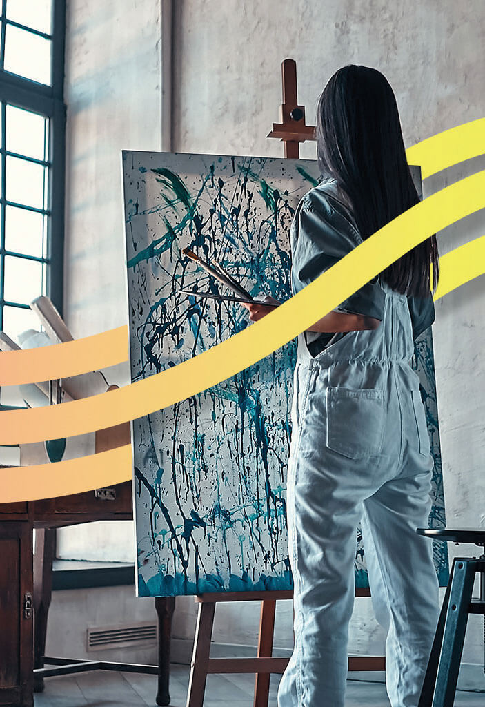 An image of a painter in a studio working on a painting overlaid with brand graphics.