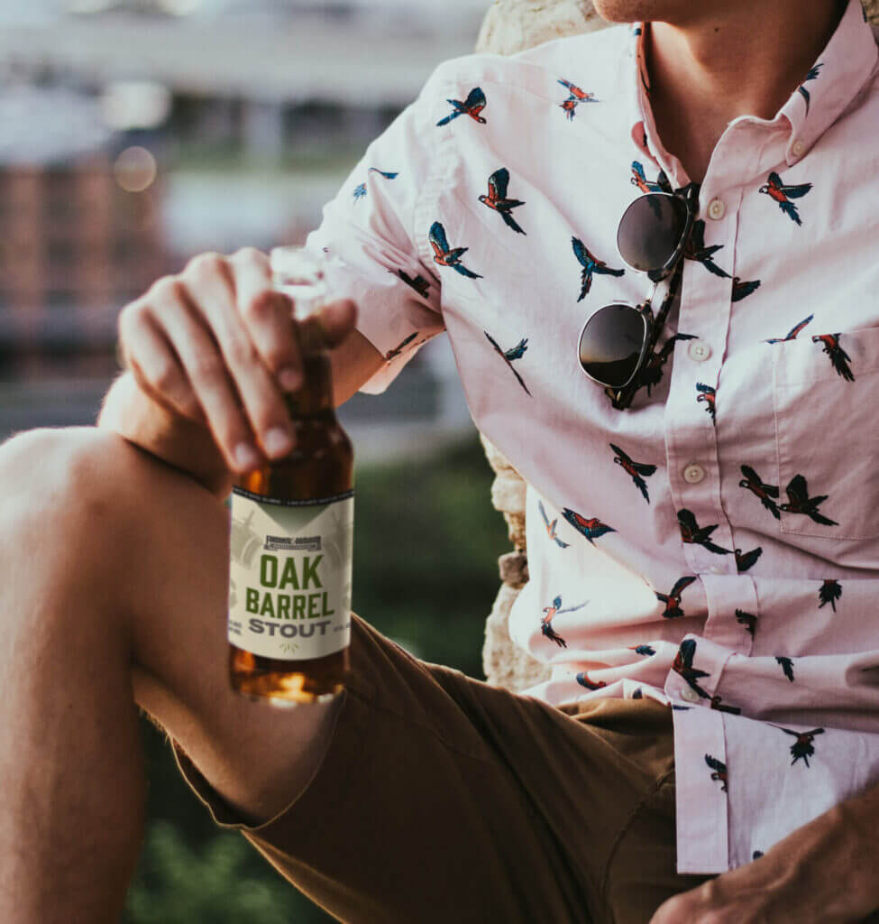 Man holding an Oak Barrel Stout.
