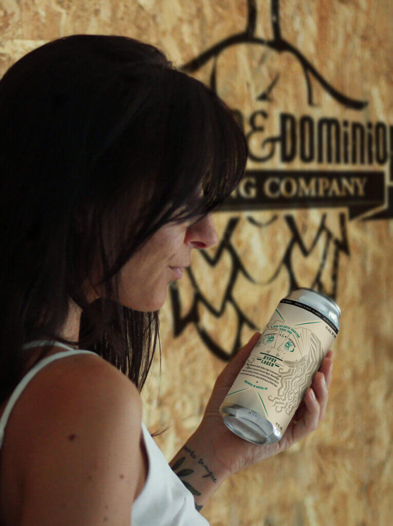 Woman holding a Fordham & Dominion can.
