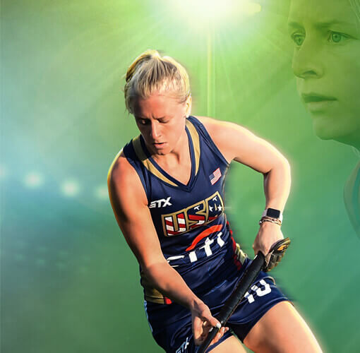 A female field hockey player playing field hockey.
