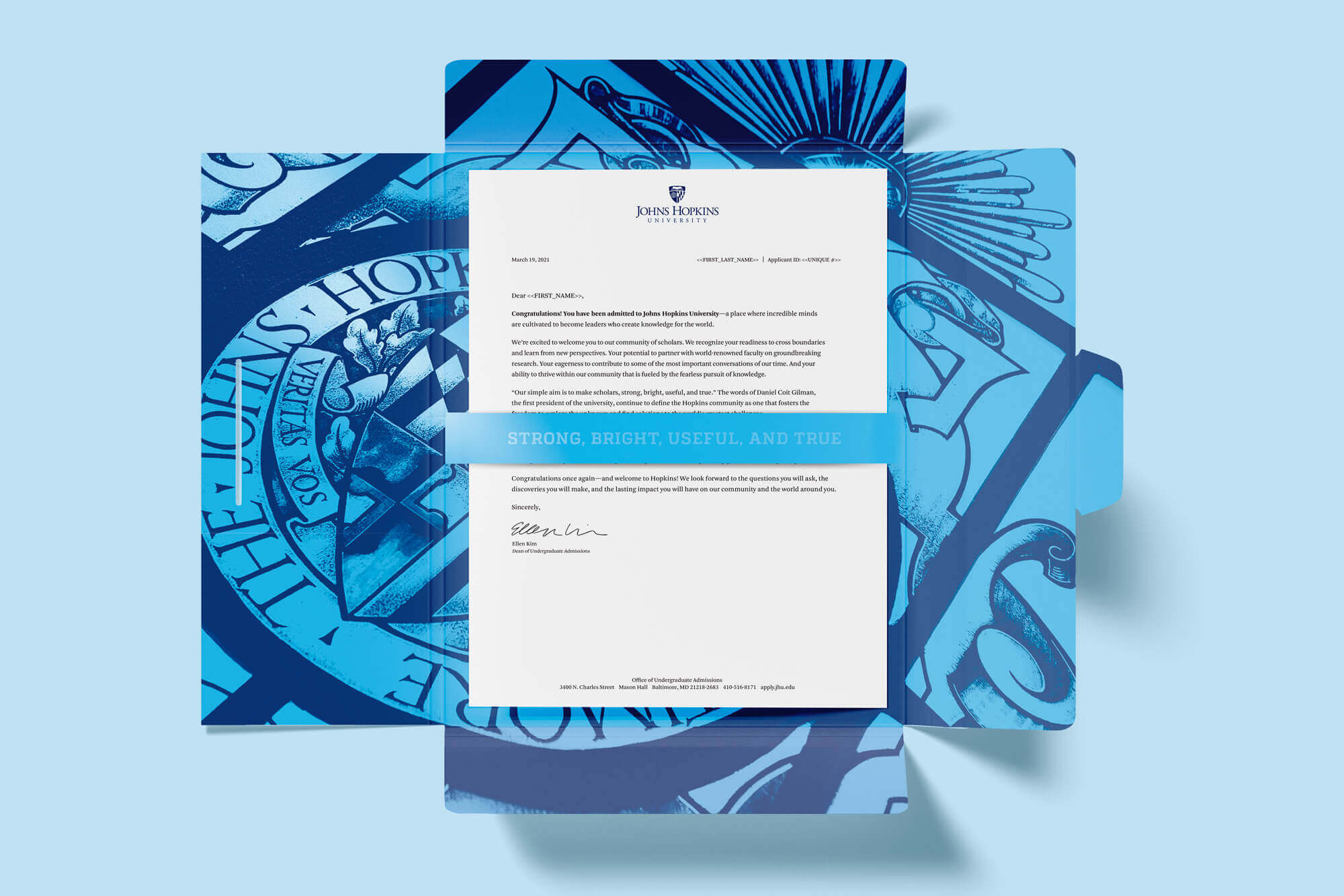Folder open to reveal stained glass design and acceptance letter.