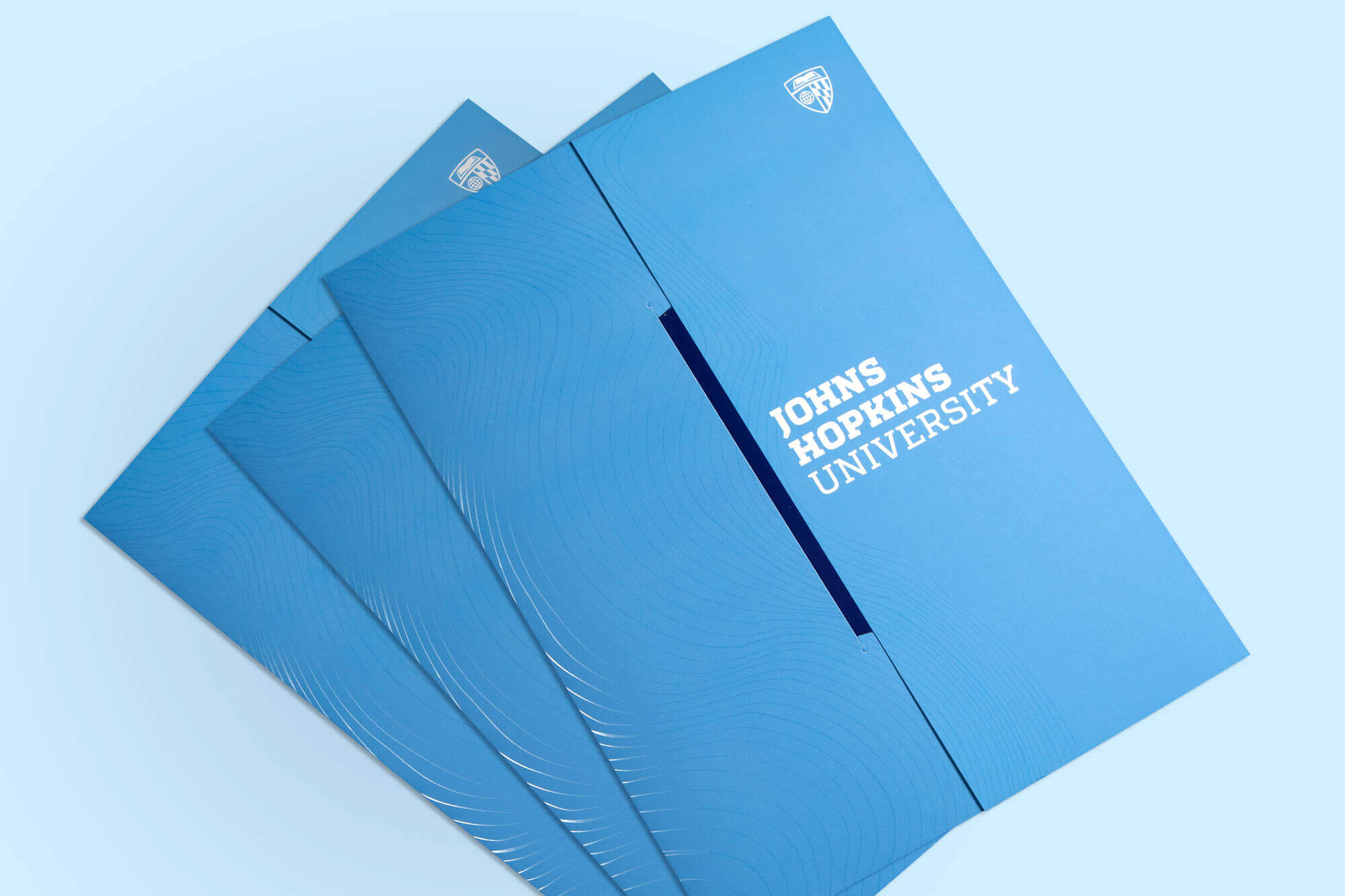 Spirit blue folder with Johns Hopkins University branding.