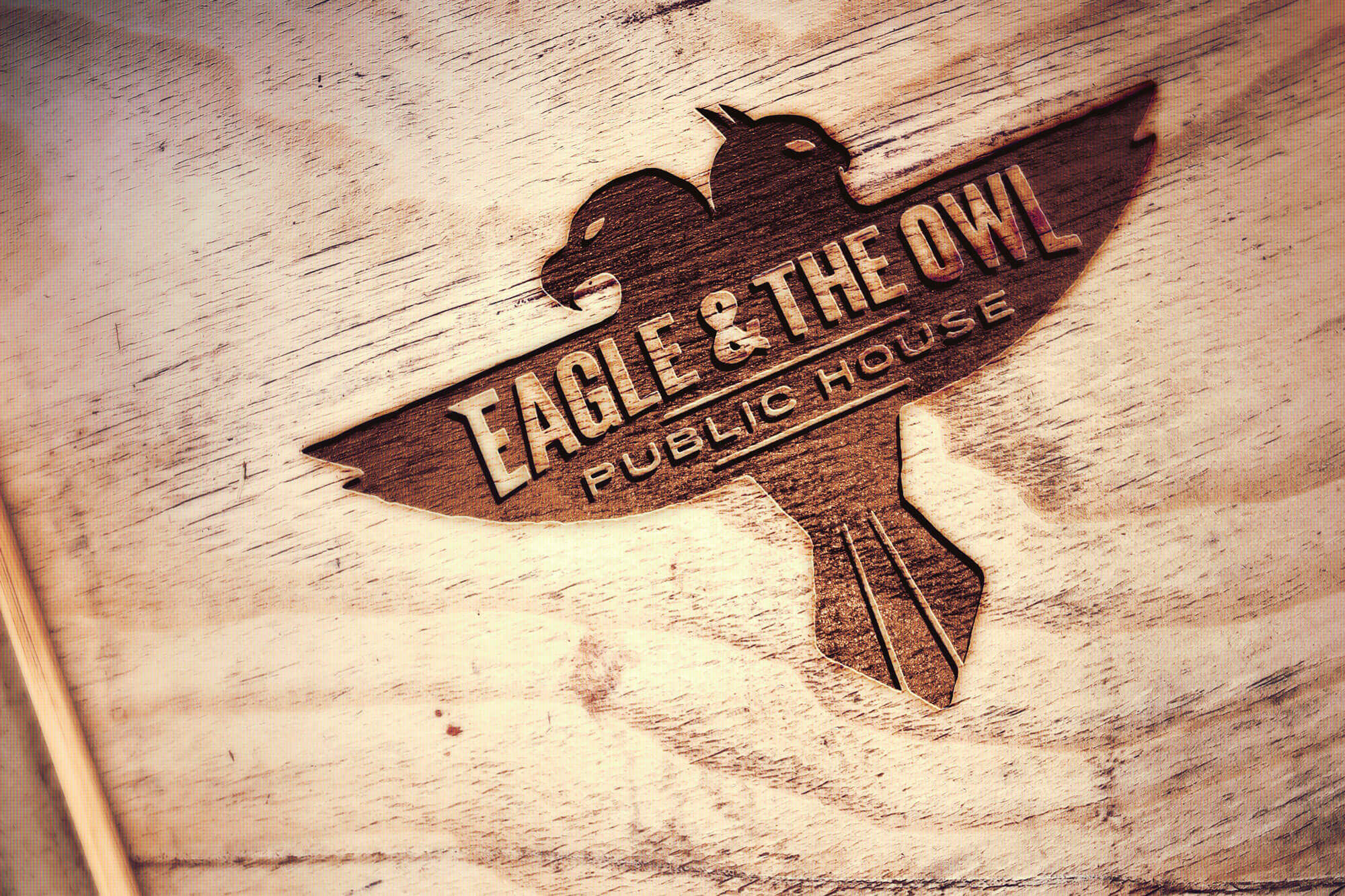 Wood branded with Eagle & The Owl Public House logo.