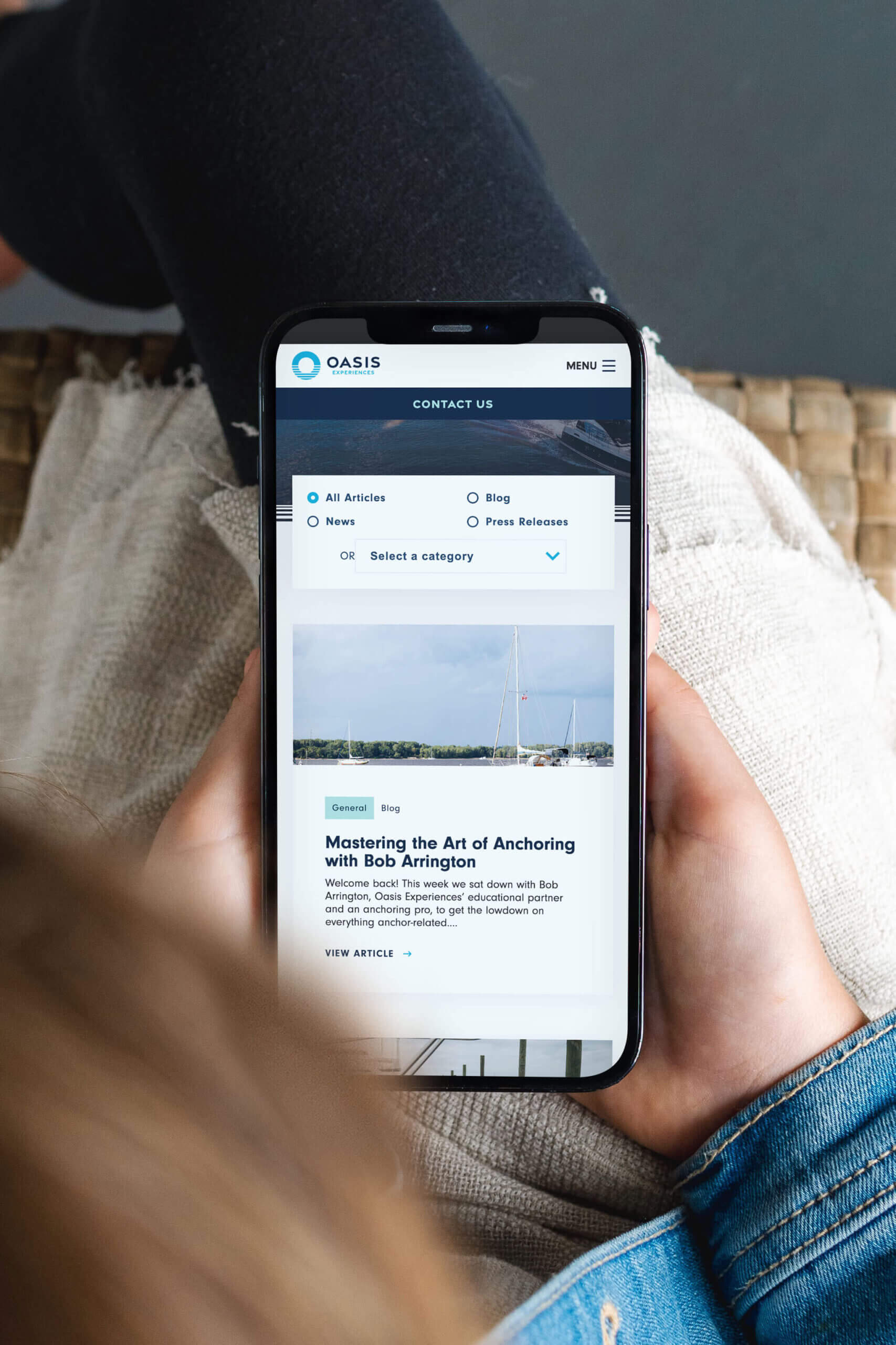 A phone screen displaying how the Oasis Experiences website renders on a phone screen.