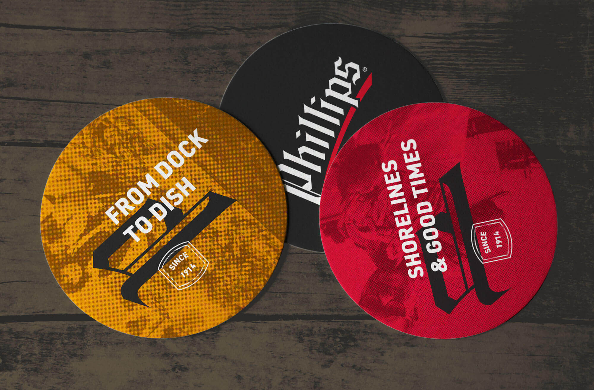 Three Phillips Seafood branded coasters.