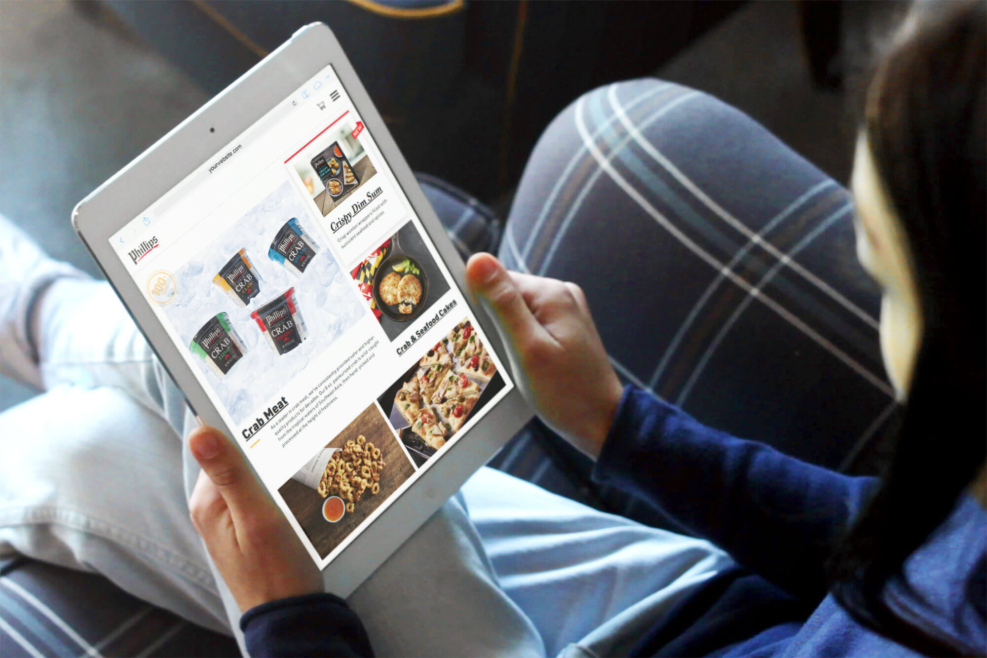 A tablet screen displaying the Phillips Seafood website.