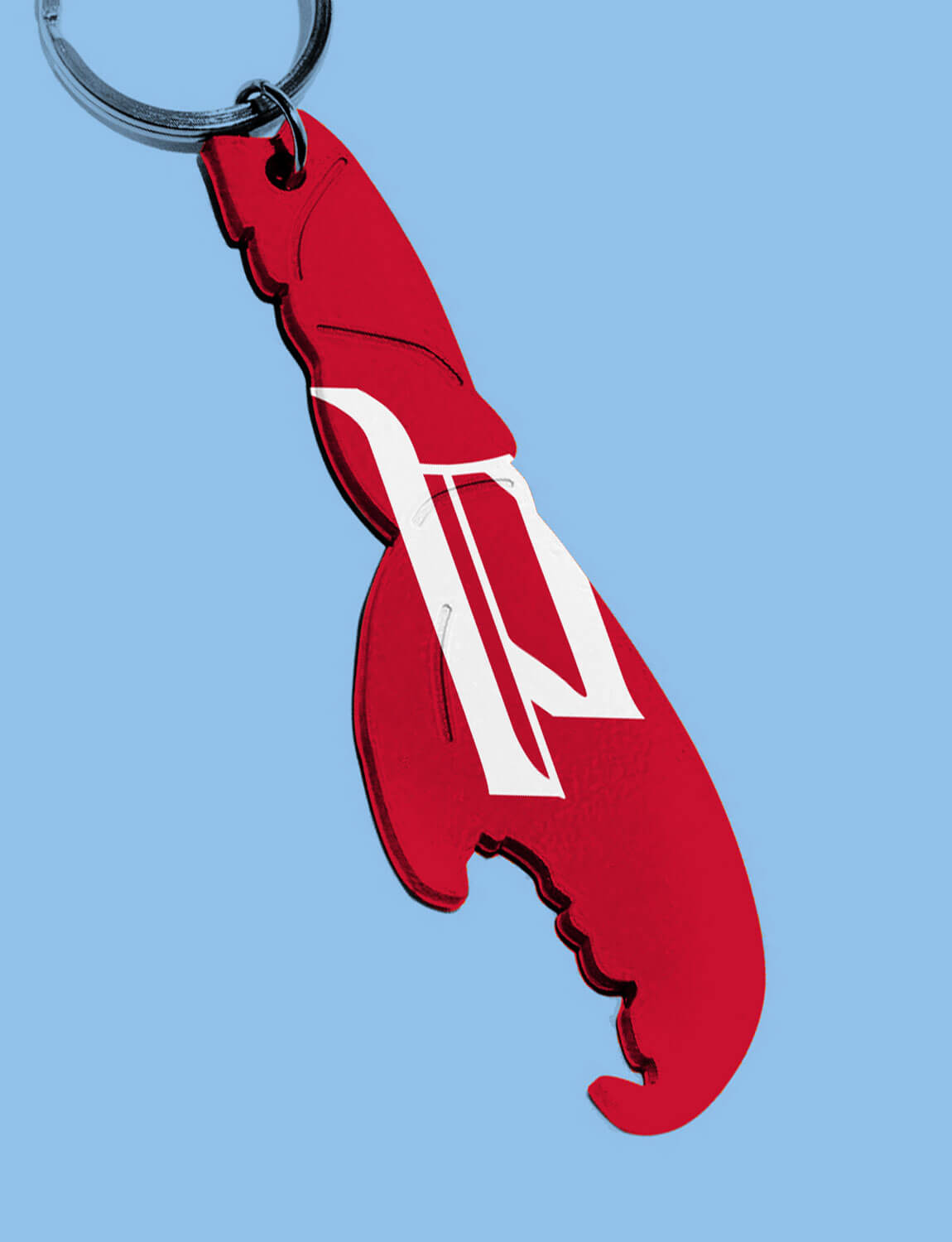 A crab claw-shaped bottle opener keychain.