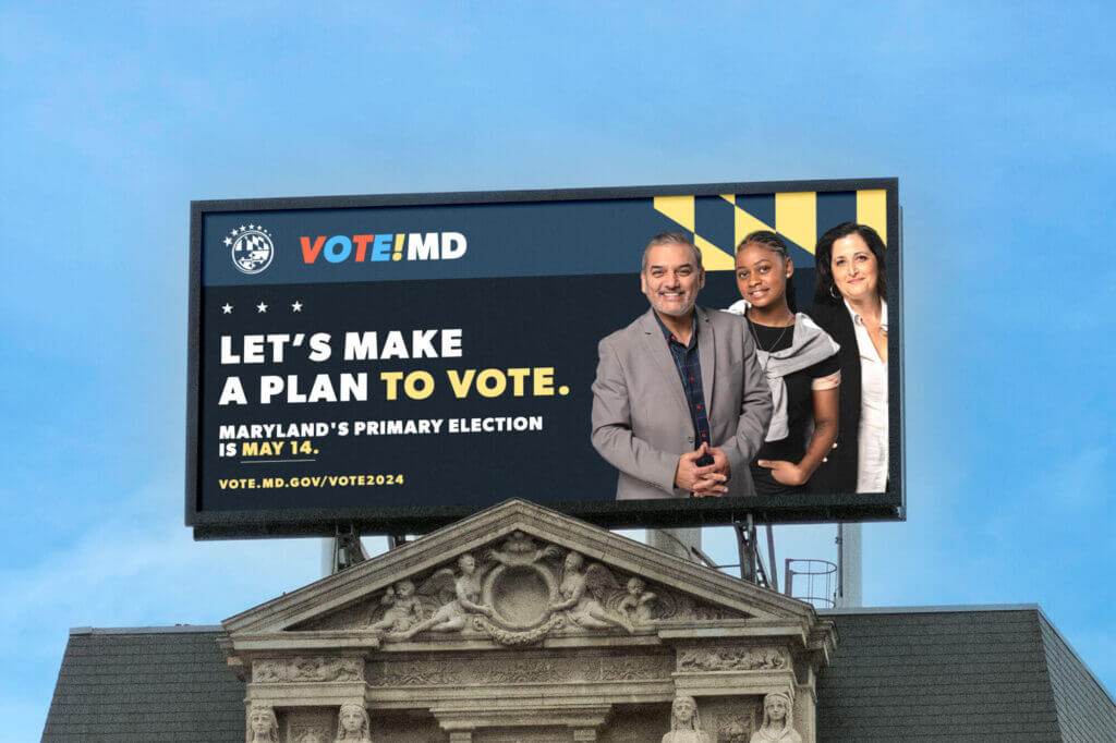 A mocked-up billboard featuring three people and campaign language, reading “let’s make a plan to vote,” appearing above some election information.