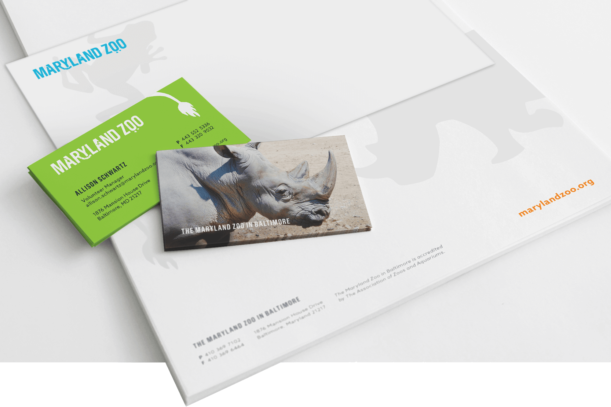 A business card and stationery featuring the Maryland Zoo logo and a picture and drawings of animals.