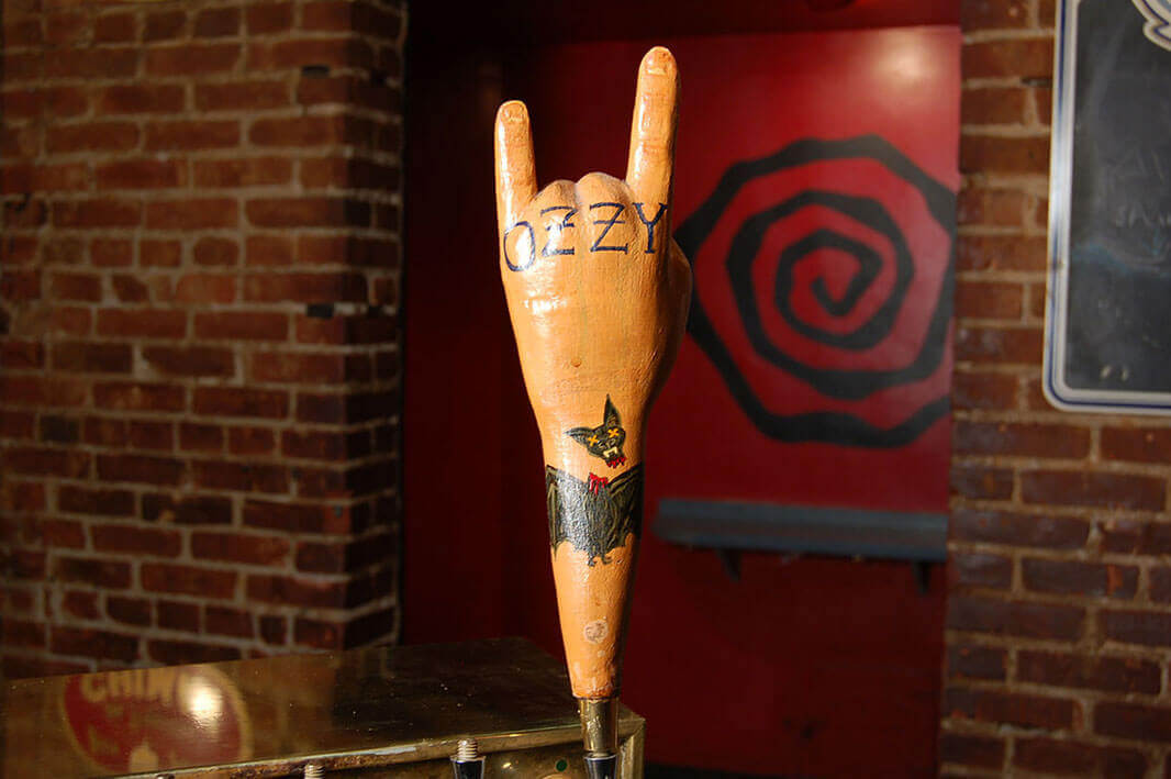 tap handle in the shape of a hand giving the 'Rock On' sign with Ozzy across the knuckles